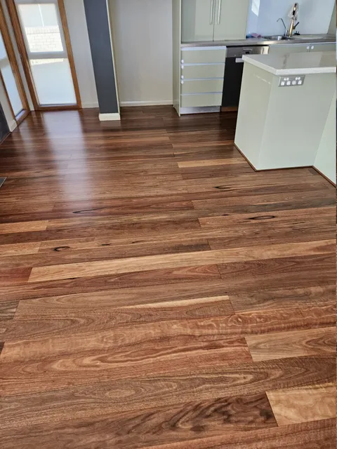 Hardwood floorboards with a satin finish in a kitchen