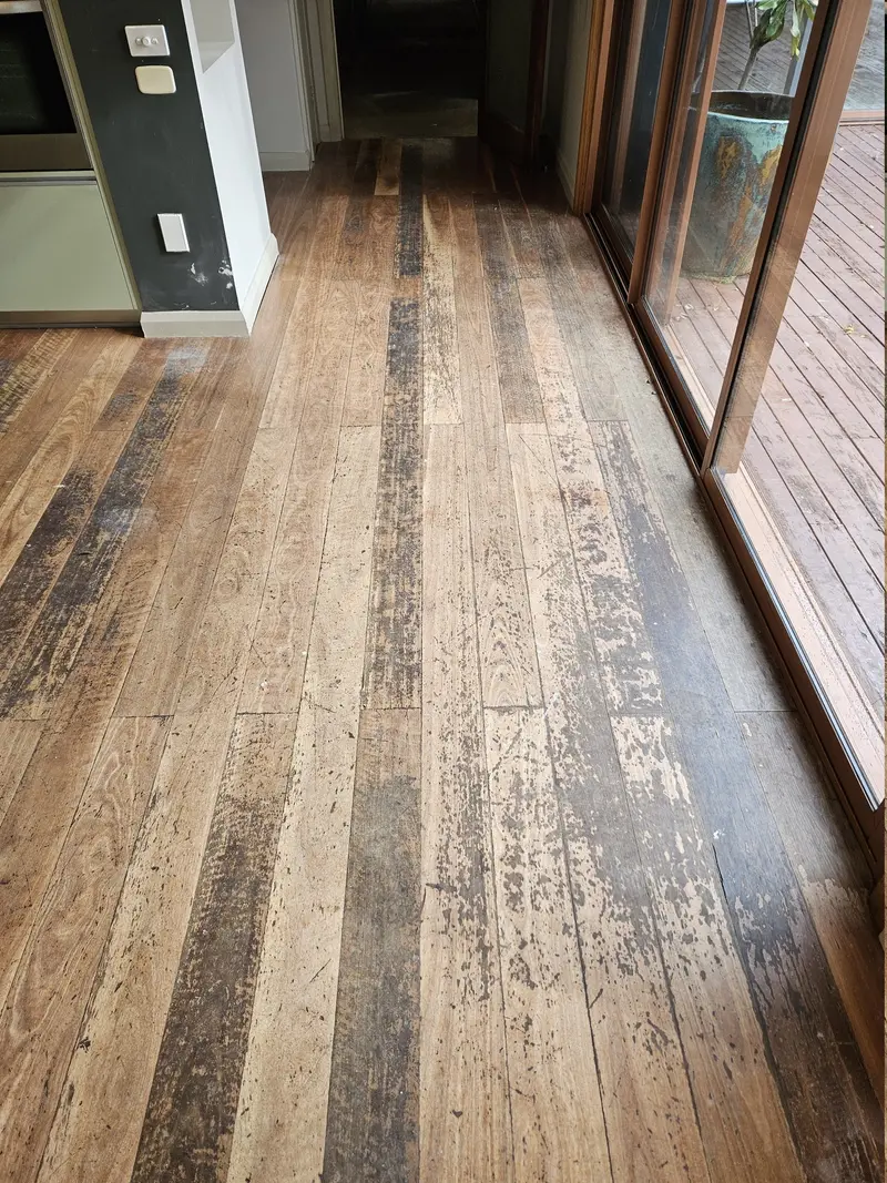 Before: worn, patchy and stained floorboards