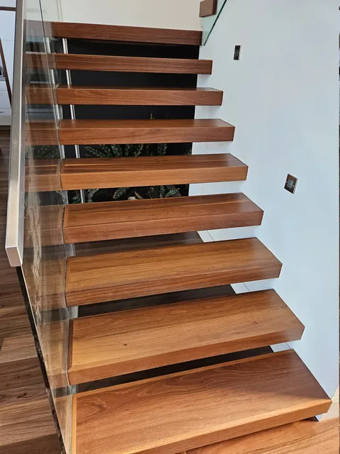 Floating timber staircase with a glass balustrade