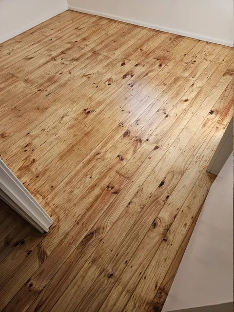 Sanded pine floorboards showing their natural knots